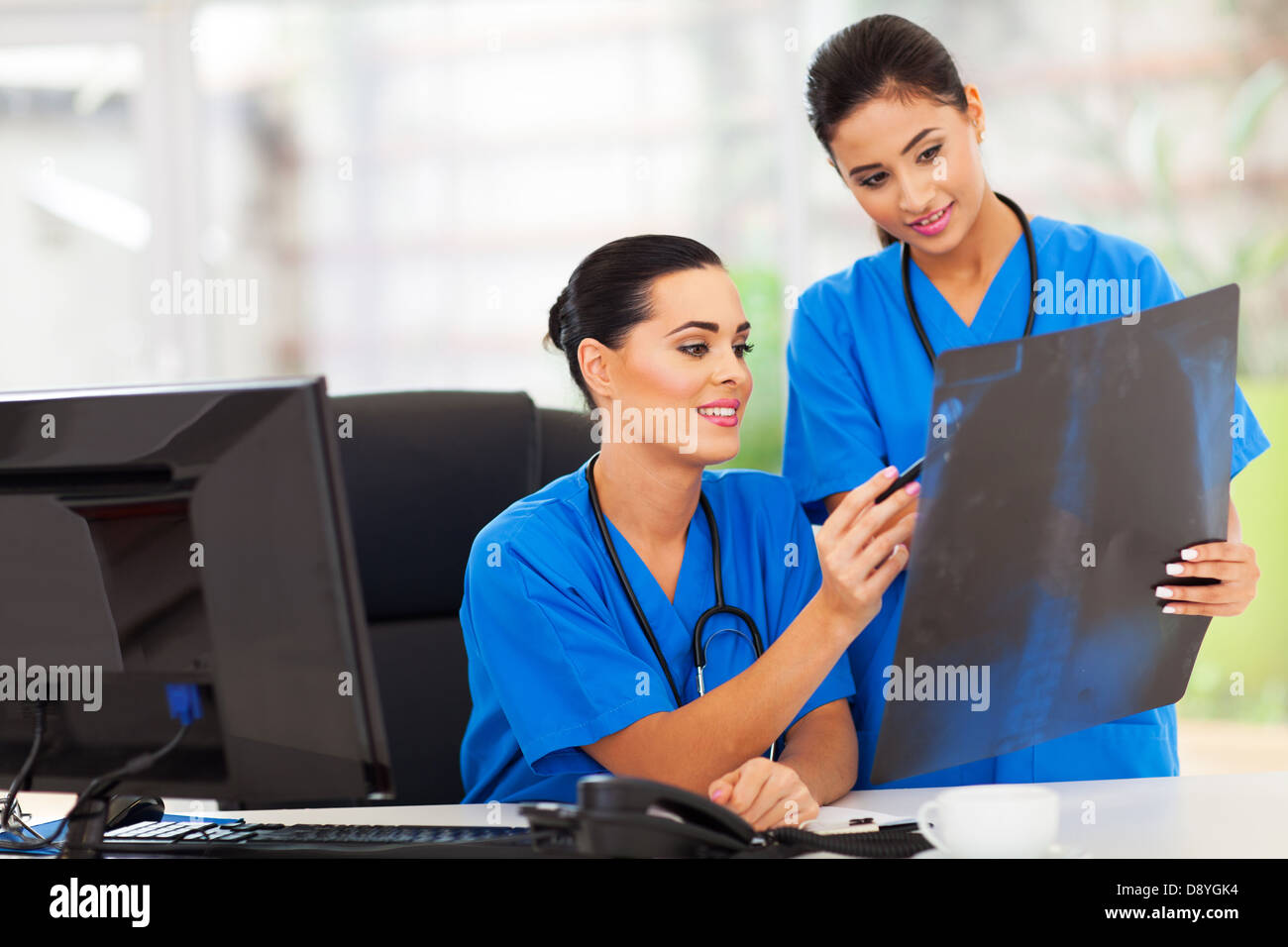 beautiful woman medical workers studying x-ray Stock Photo