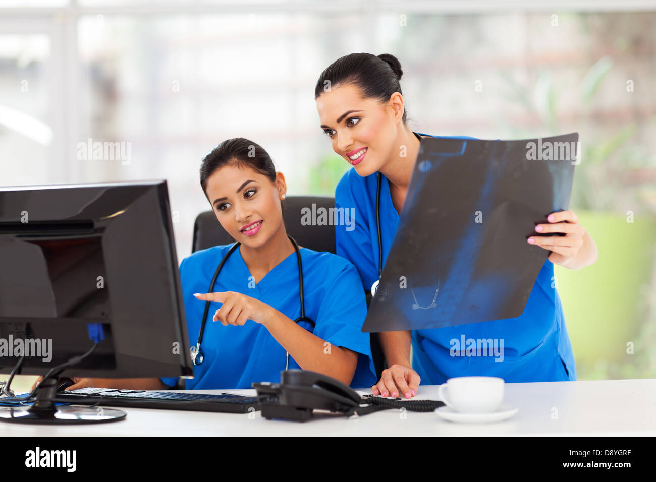 two beautiful female healthcare workers working in office Stock Photo