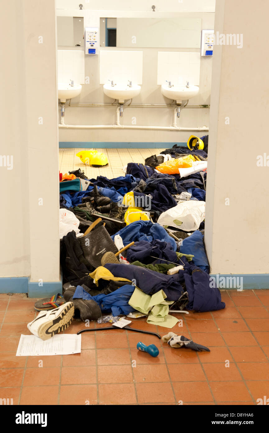 Clothes thrown all over floor in washroom Stock Photo