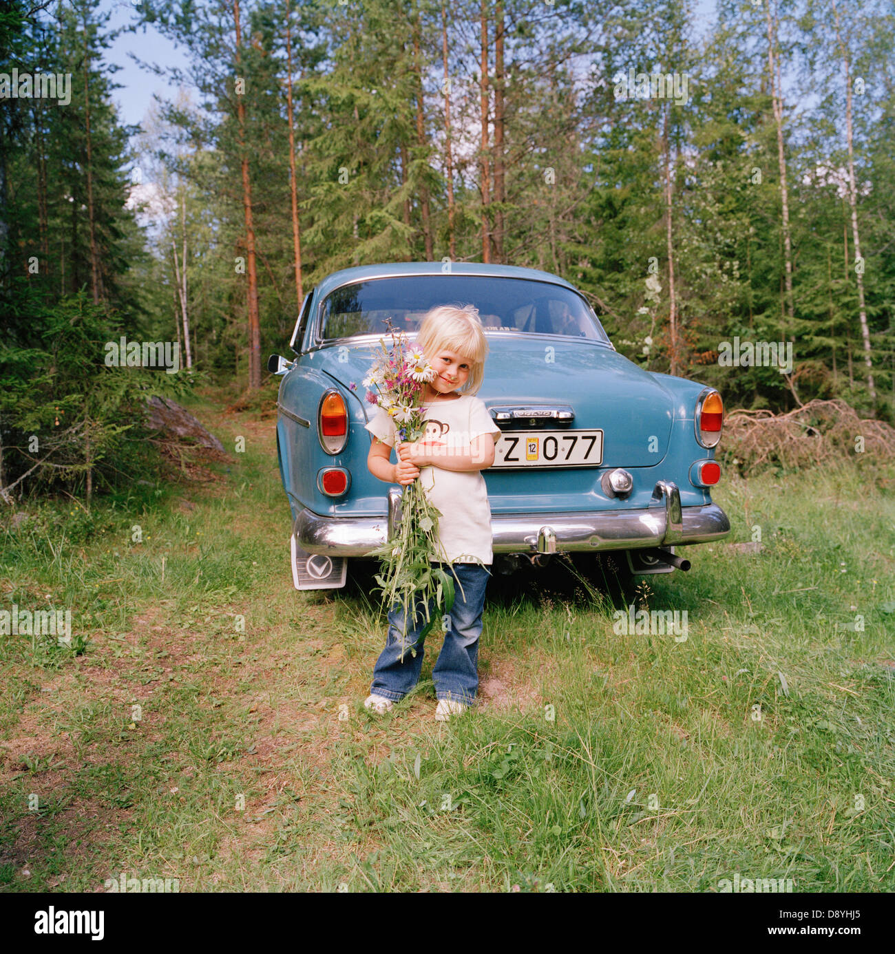 A girl in front of a Volvo Amazon, Sweden. Stock Photo