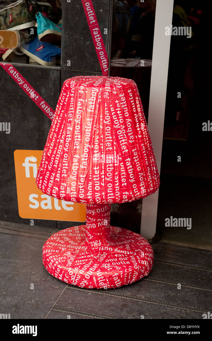 Big red table lamp wrapped up present Stock Photo