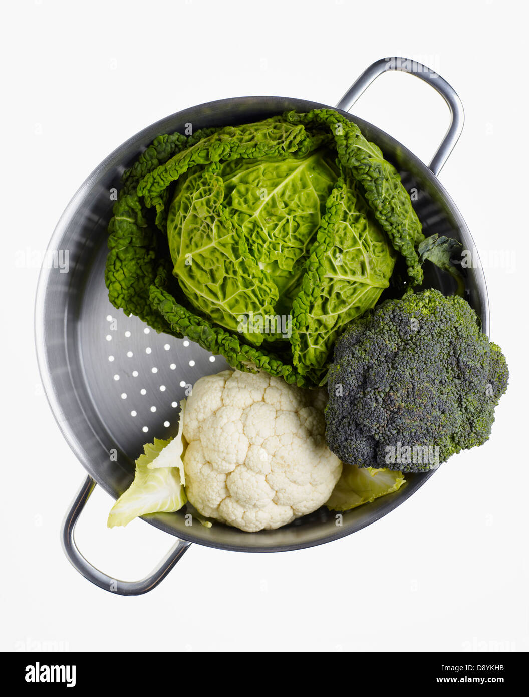 Cabbage, broccoli and cauliflower in colander, studio shot Stock Photo