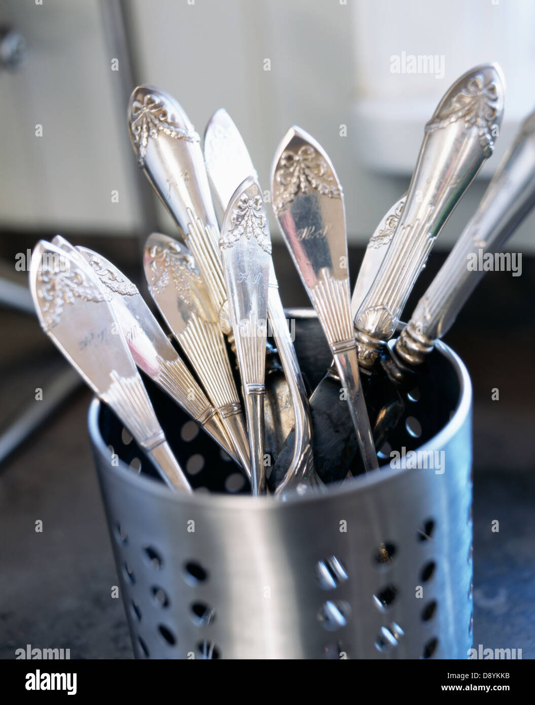 Silver cutlery in steel container Stock Photo
