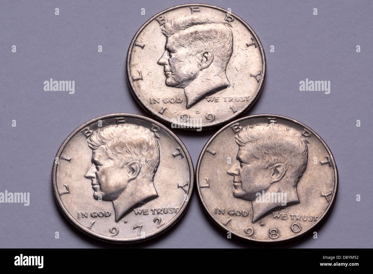 John F. Kennedy half dollar coins; one each from 1991, 1972 and 1980. Stock Photo