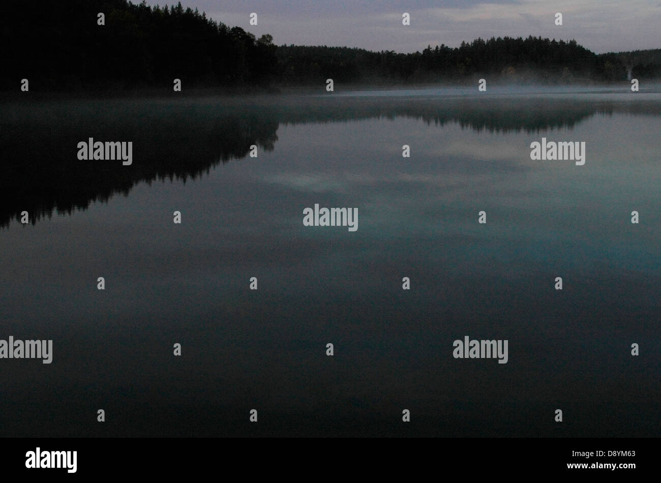 A calm lake in the darkness, Sweden. Stock Photo