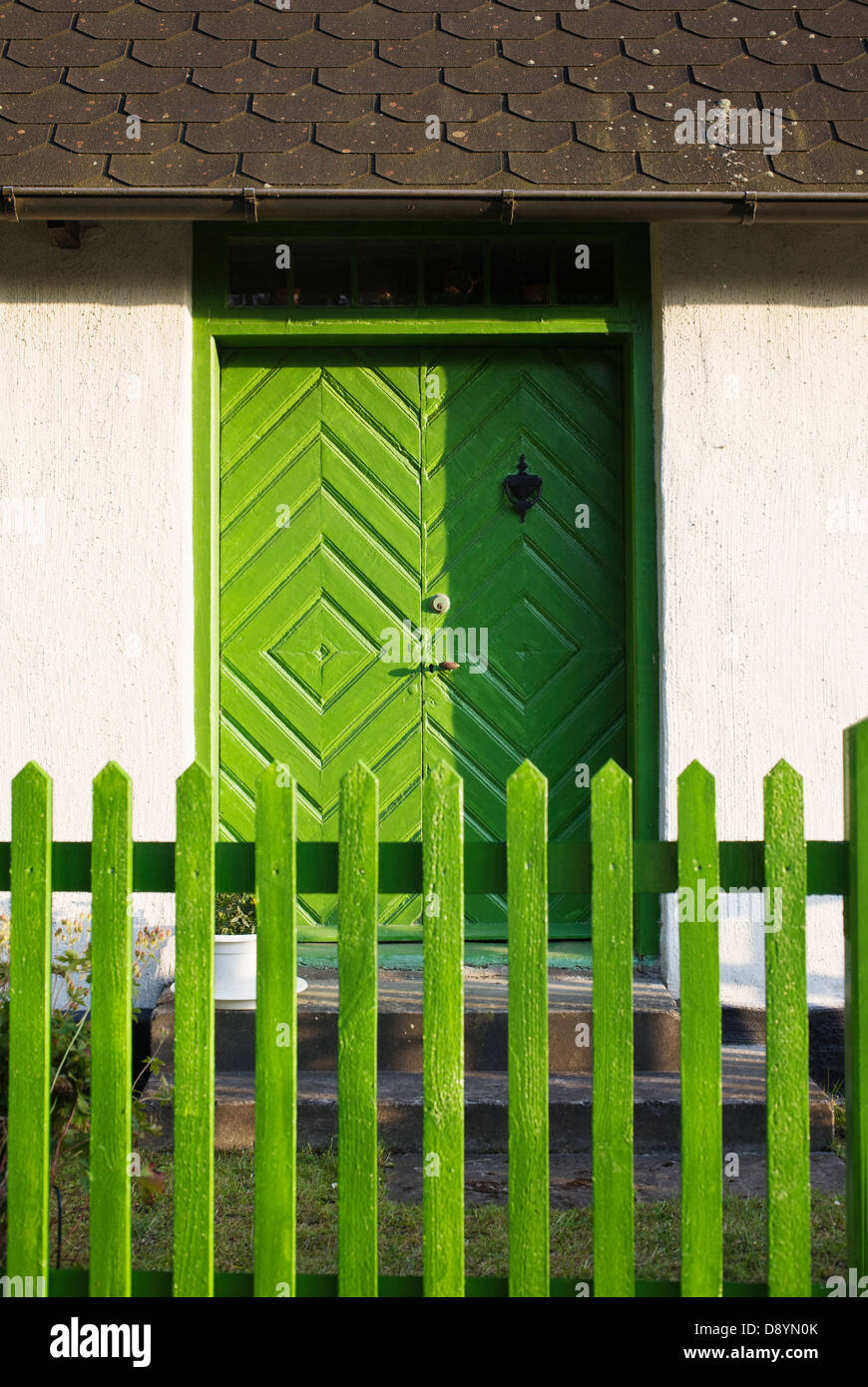 House with green door and fence Stock Photo - Alamy