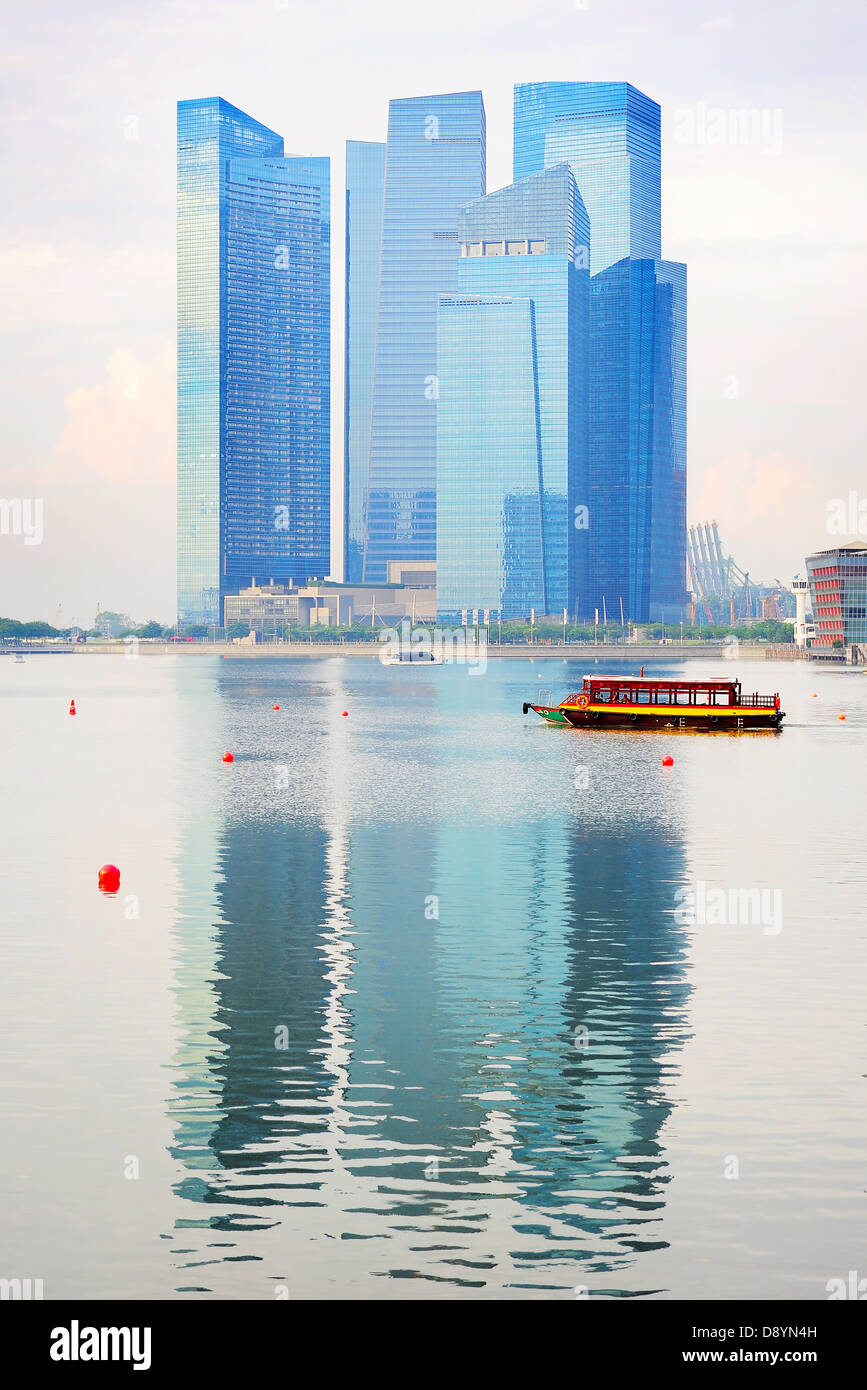 Modern office building reflected in Singapore river Stock Photo