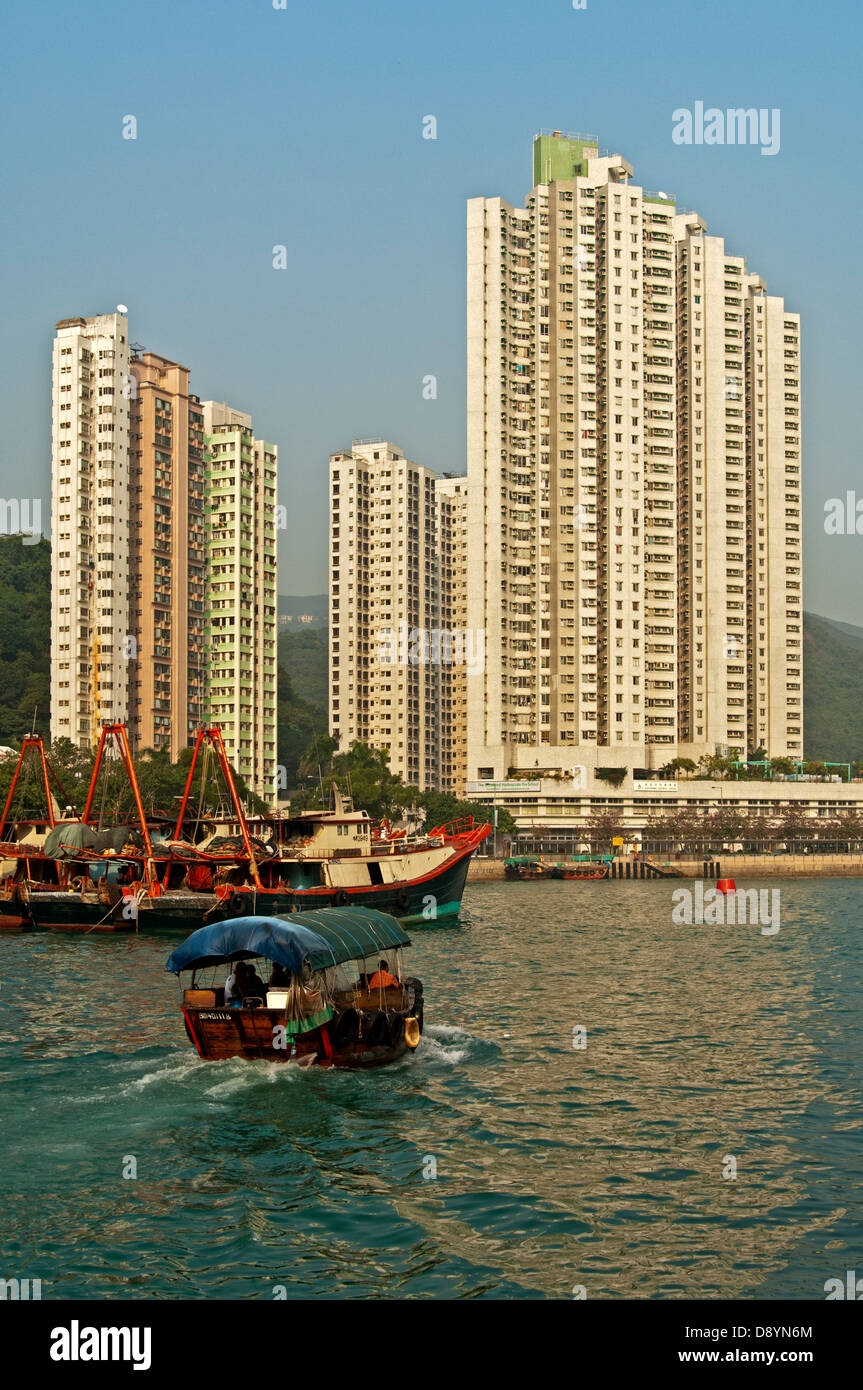 Sampan boat in the Aberdeen Harbour, skyscrapers overlooking the Aberdeen Channel, Aberdeen, Hong Kong Stock Photo