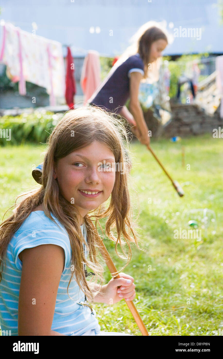 Two girls playing croquet Stock Photo Alamy