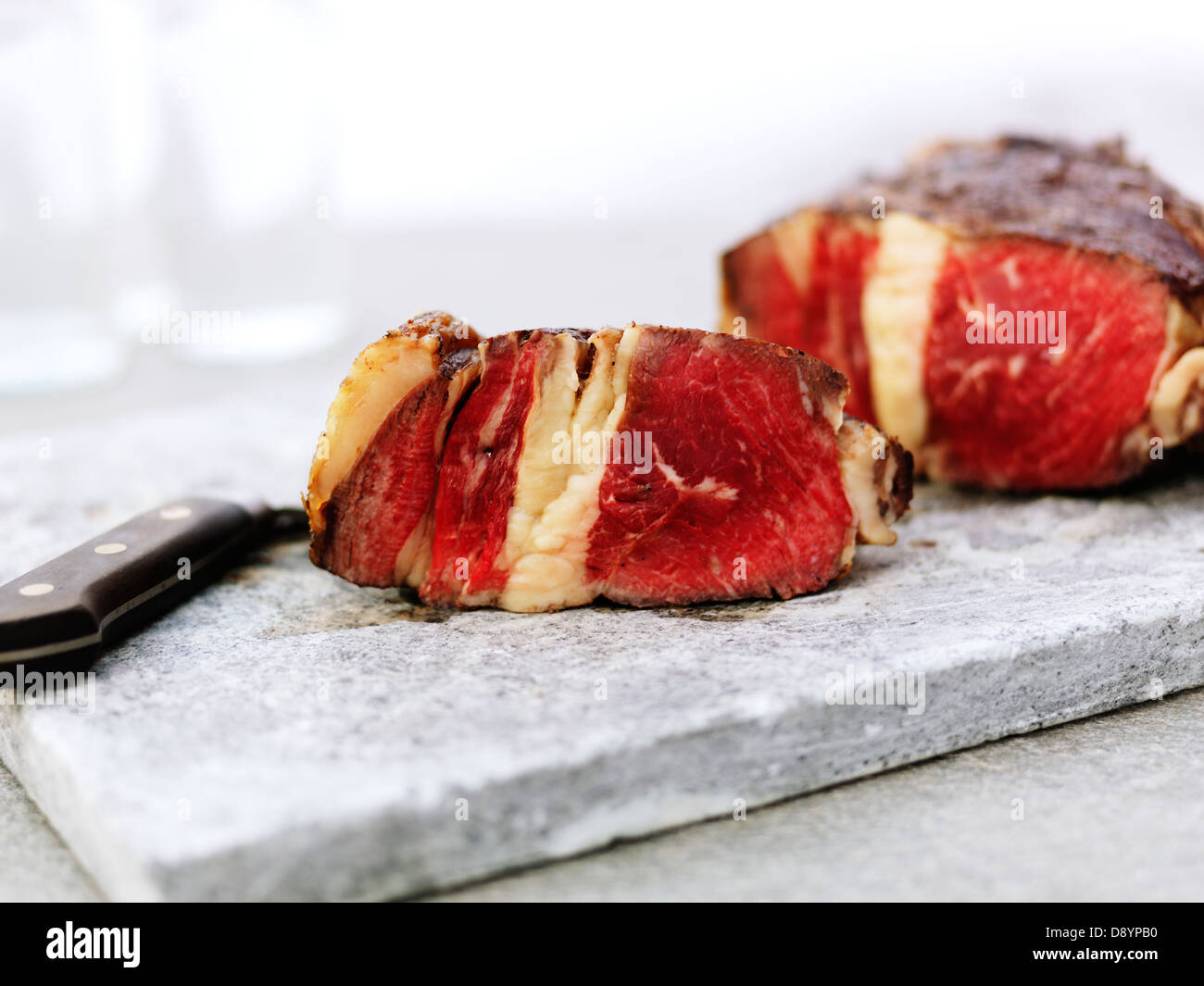 Close up of red meat slices on cutting board Stock Photo