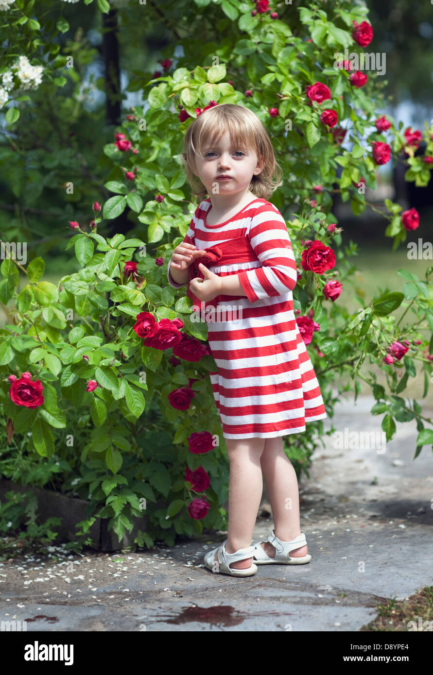 Girl holding flowers in garden, portrait Stock Photo - Alamy