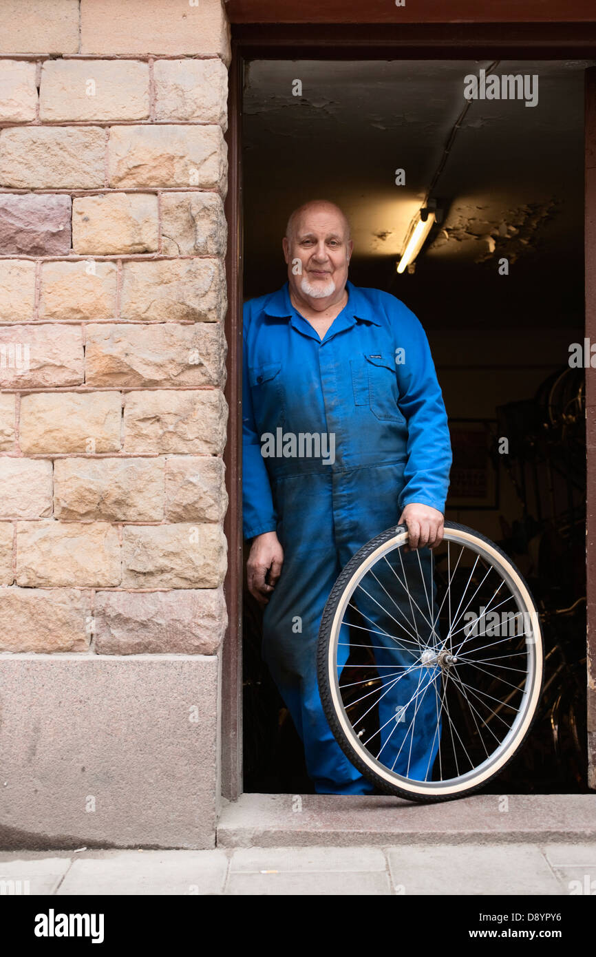 Man repairs wheel bicycle shop hi res stock photography and images Alamy