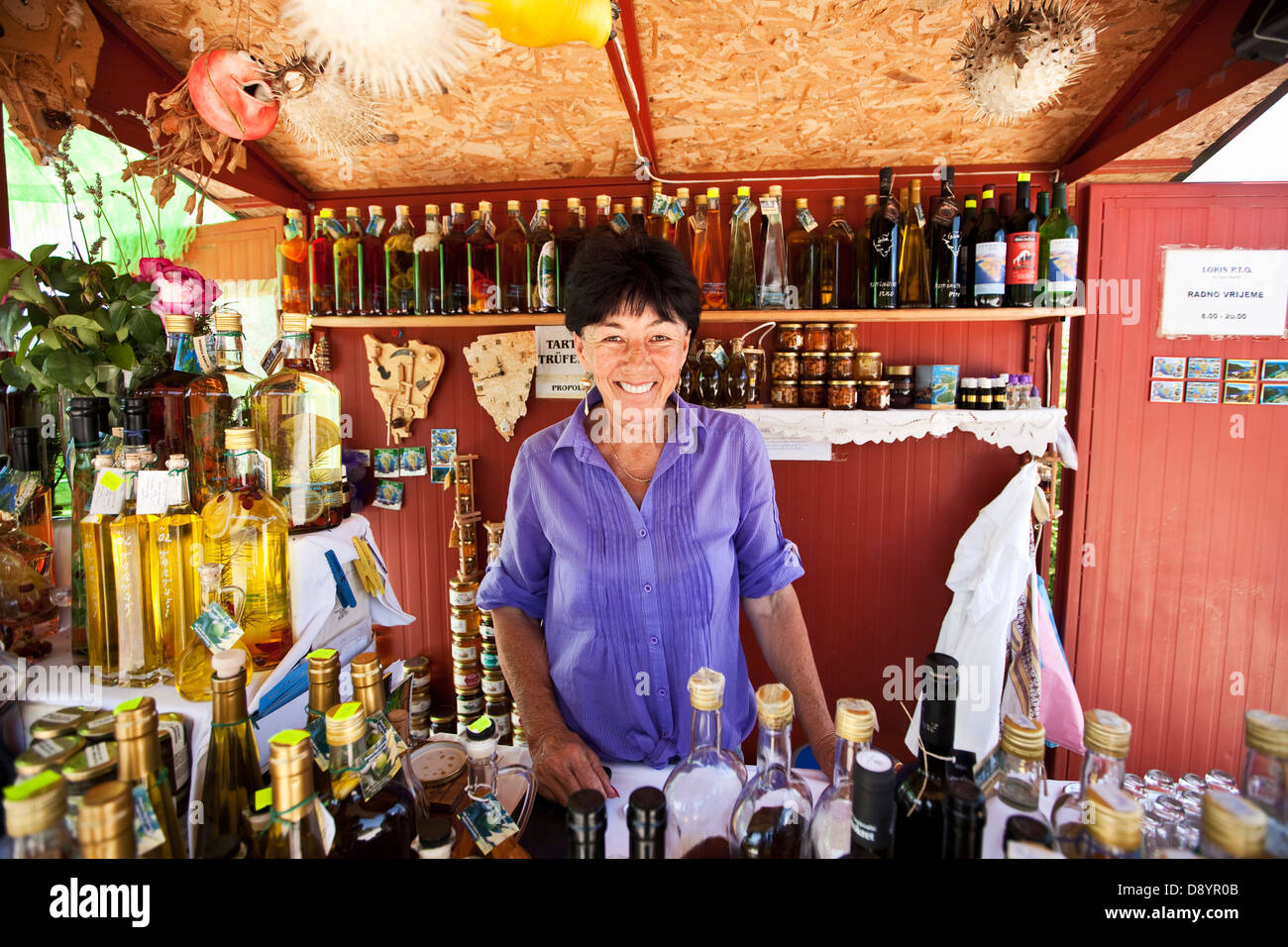 Happy woman in a souvenier stand Stock Photo