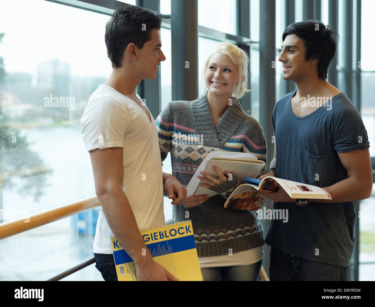 Teenagers standing in corridor in school Stock Photo - Alamy