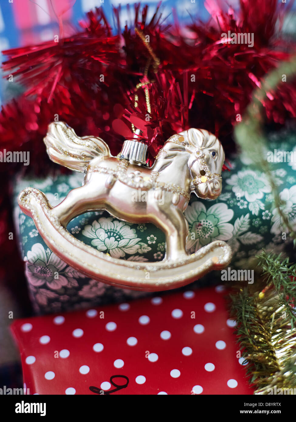 Rocking horse shaped christmas bauble and gifts Stock Photo