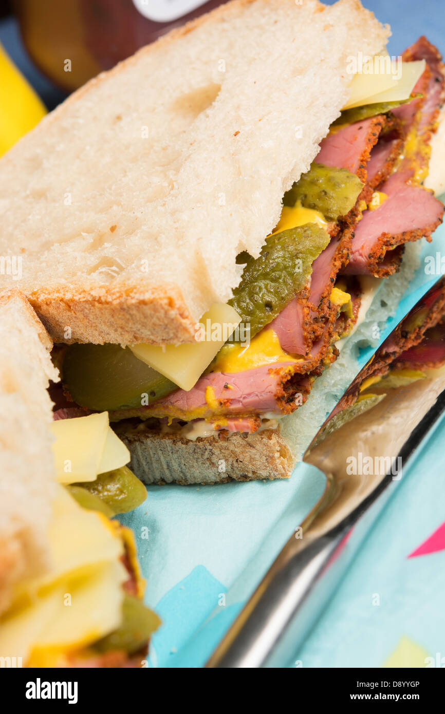 A delistyle sandwich of pastrami, Emmenthal cheese, sliced gherkins