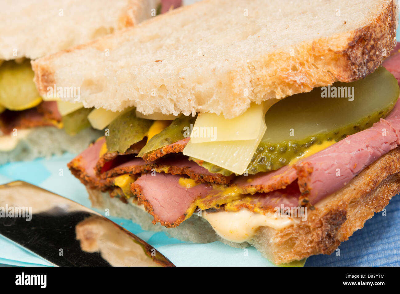 A delistyle sandwich of pastrami, Emmenthal cheese, sliced gherkins