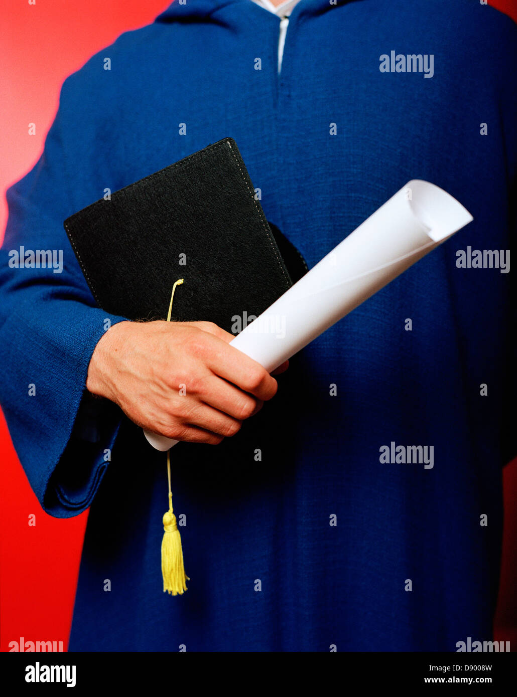 A graduate with a cap and a diploma. Stock Photo