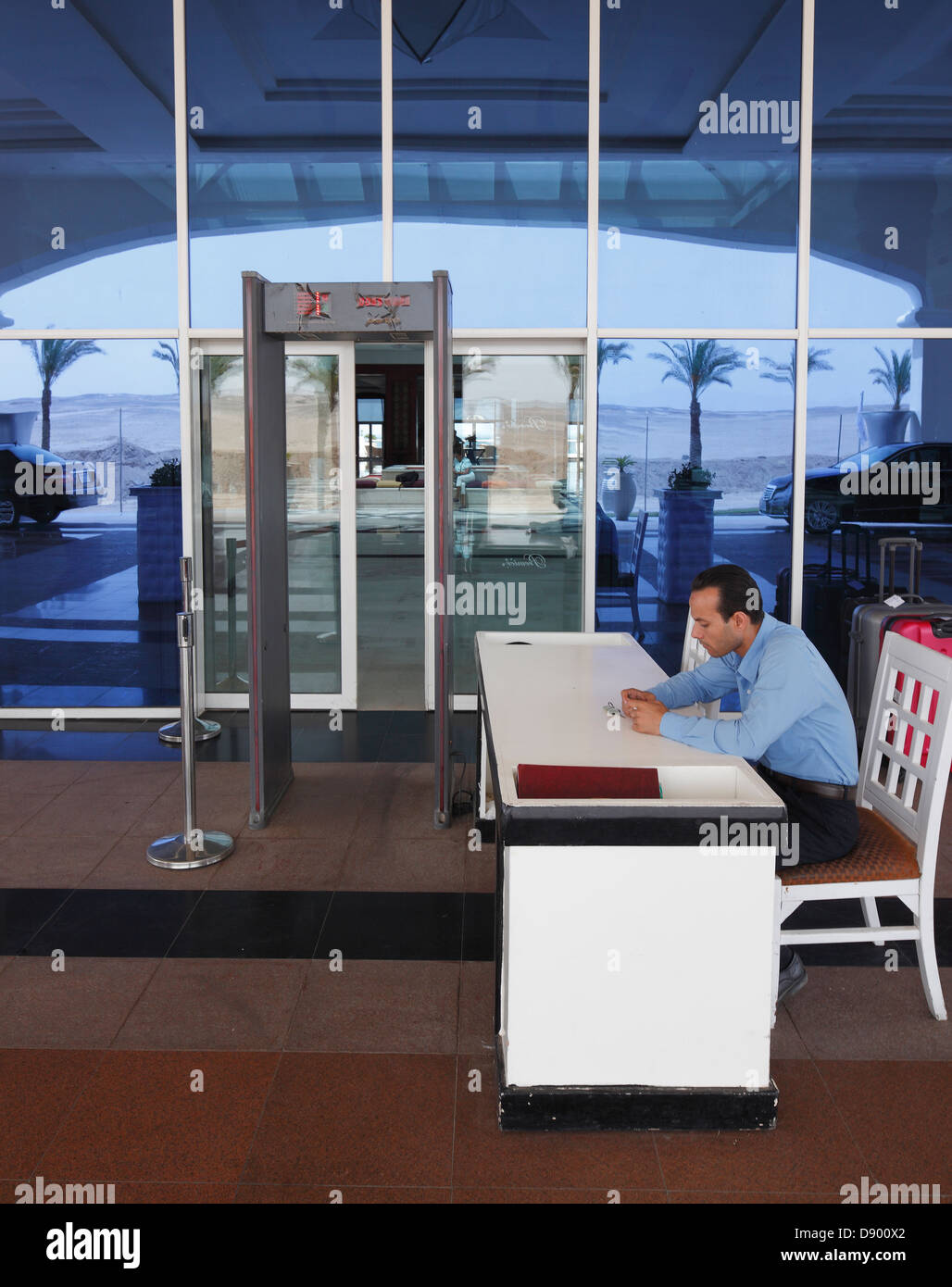 Airport type Metal detector and security man at the entrance to an