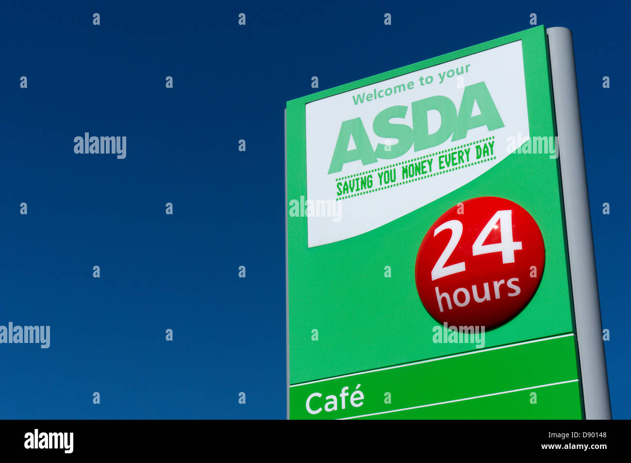 A green Asda supermarket sign against a clear blue sky. Stock Photo