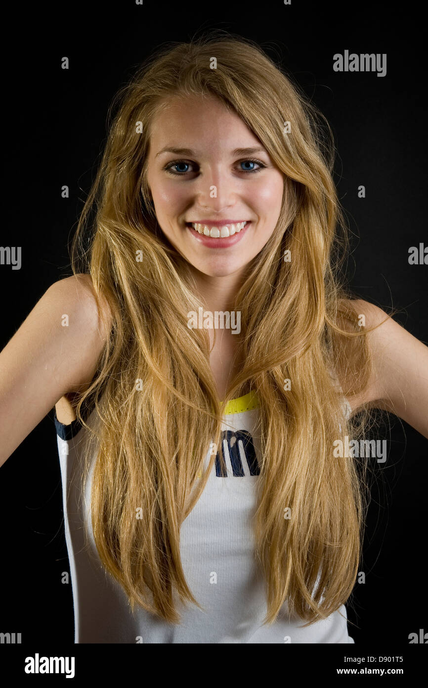 Portrait of a young woman on black background Stock Photo - Alamy