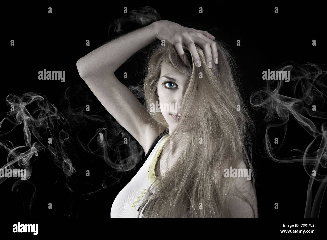 Portrait of a young woman on black background Stock Photo - Alamy