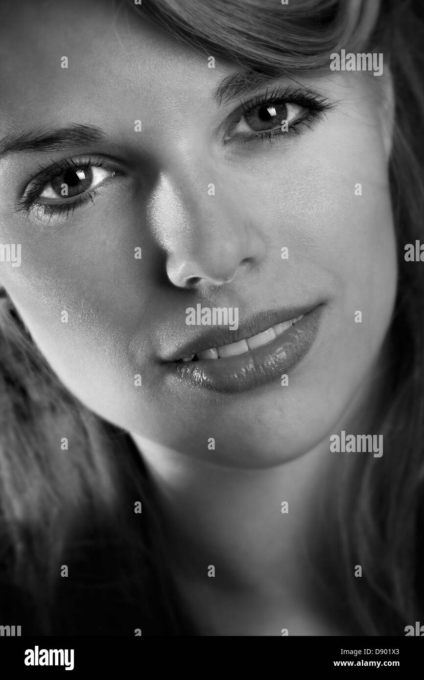 Portrait of a young woman on black background Stock Photo - Alamy
