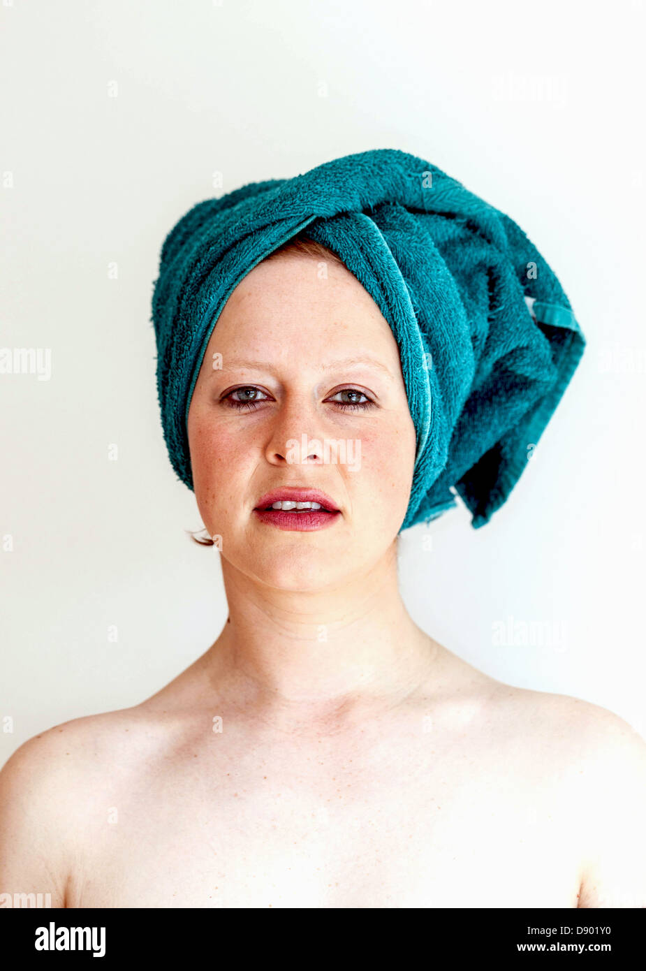 Medium close up portrait of a woman wearing a head towel, London, England, UK. Stock Photo
