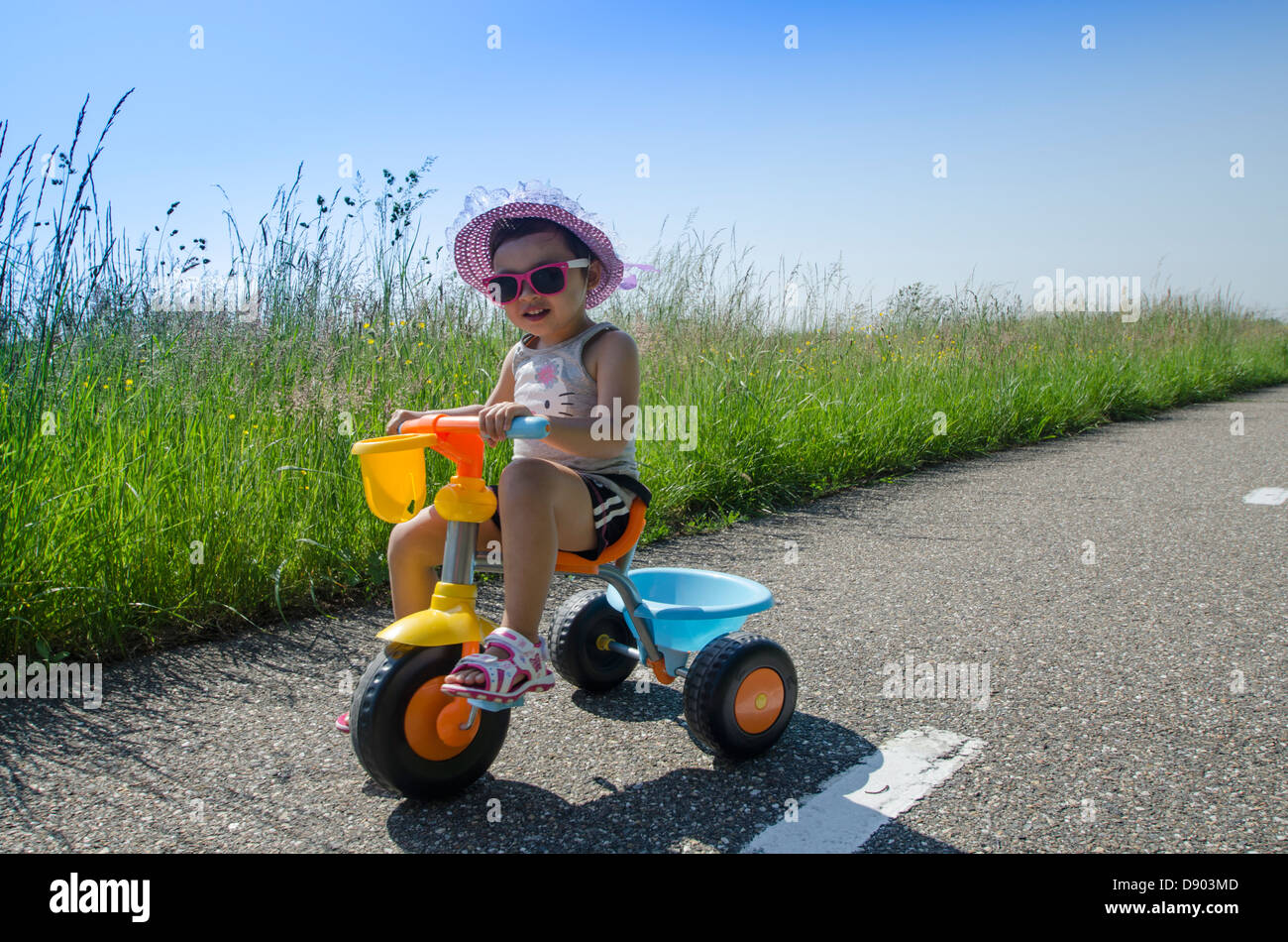 Young girl tricycle bicycle hi-res stock photography and images - Alamy