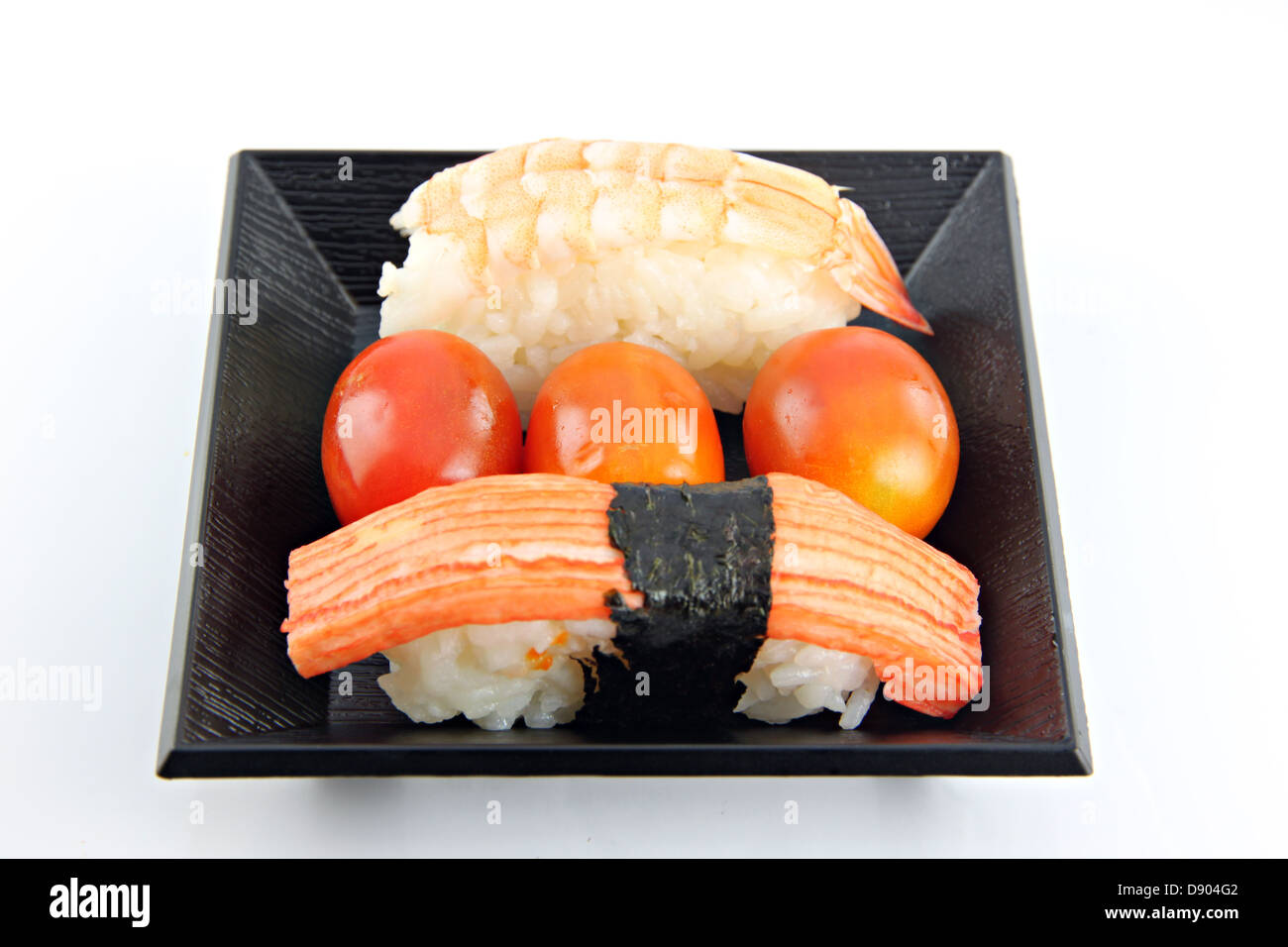 Tomato and sushi seafood in a bowl on the white background. Stock Photo