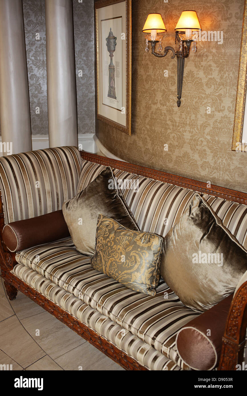 Upholstered chair with accenting cushions Stock Photo Alamy