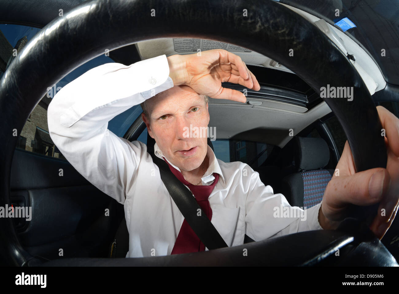 tired businessman driving car Stock Photo