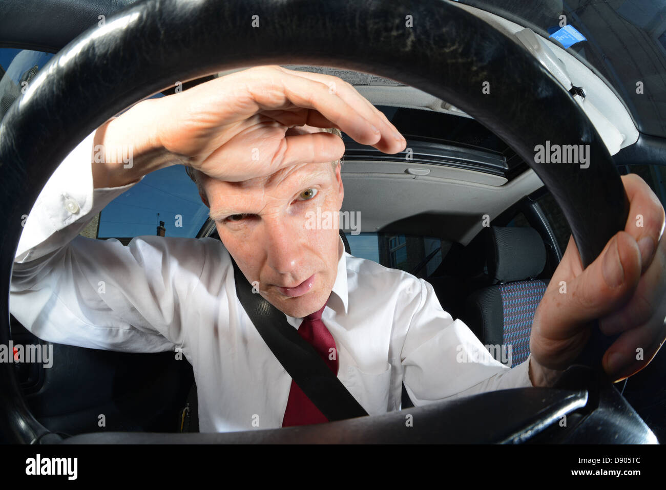 tired businessman driving car Stock Photo