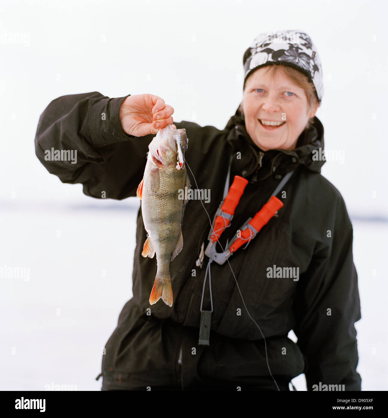 A woman showing a perch. Stock Photo