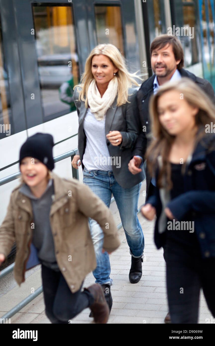 Family with two kids boarding on tram Stock Photo