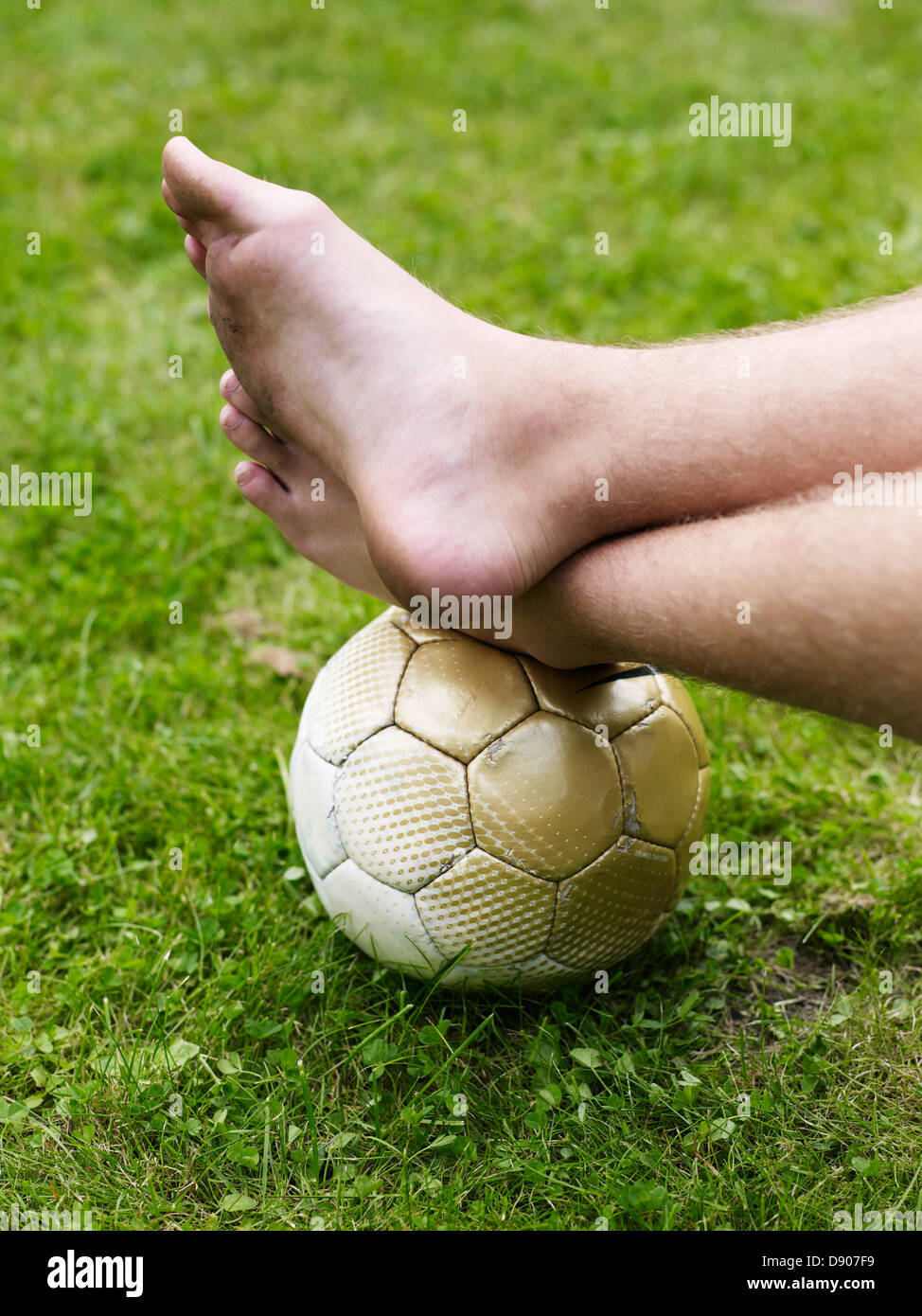 Bare foot on soccer ball Stock Photo