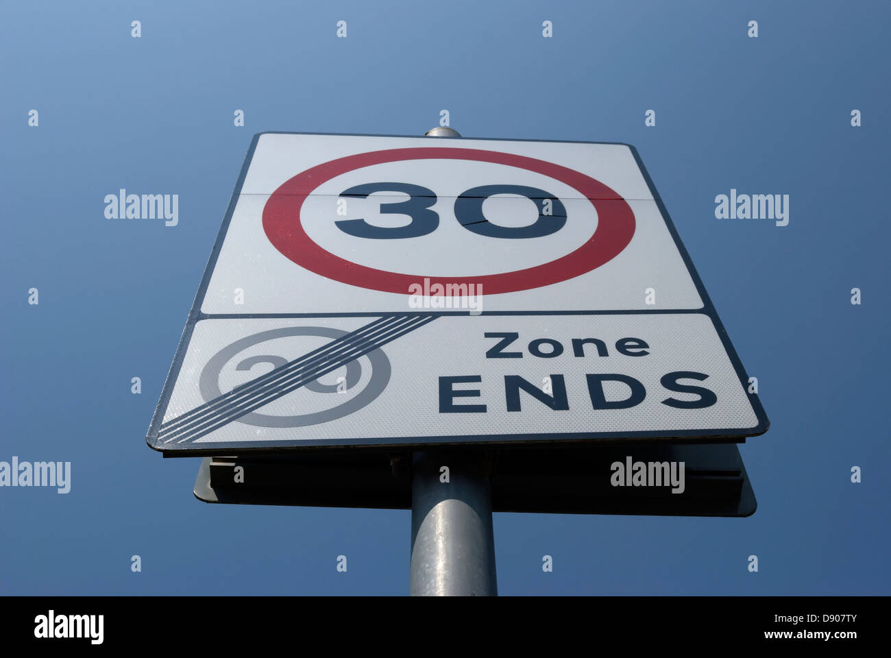 british road sign indicating end of 20mph zone and start of 30mph zone Stock Photo