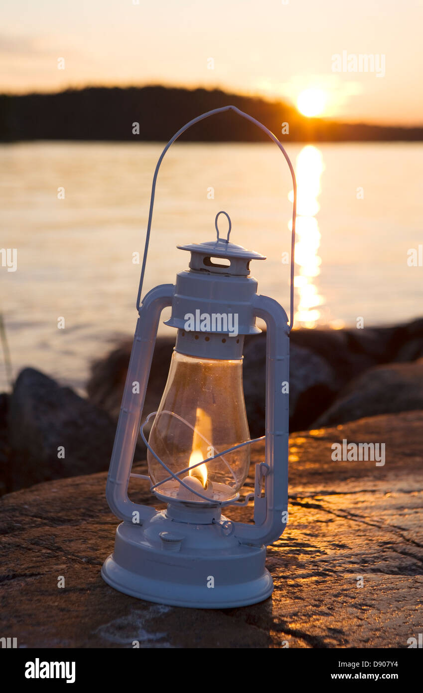 A paraffin lamp on a flat piece of rock, Stockholm archipelago, Sweden. Stock Photo