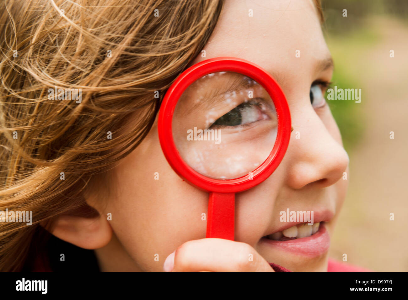 Portrait of girl with magnifying glass Stock Photo