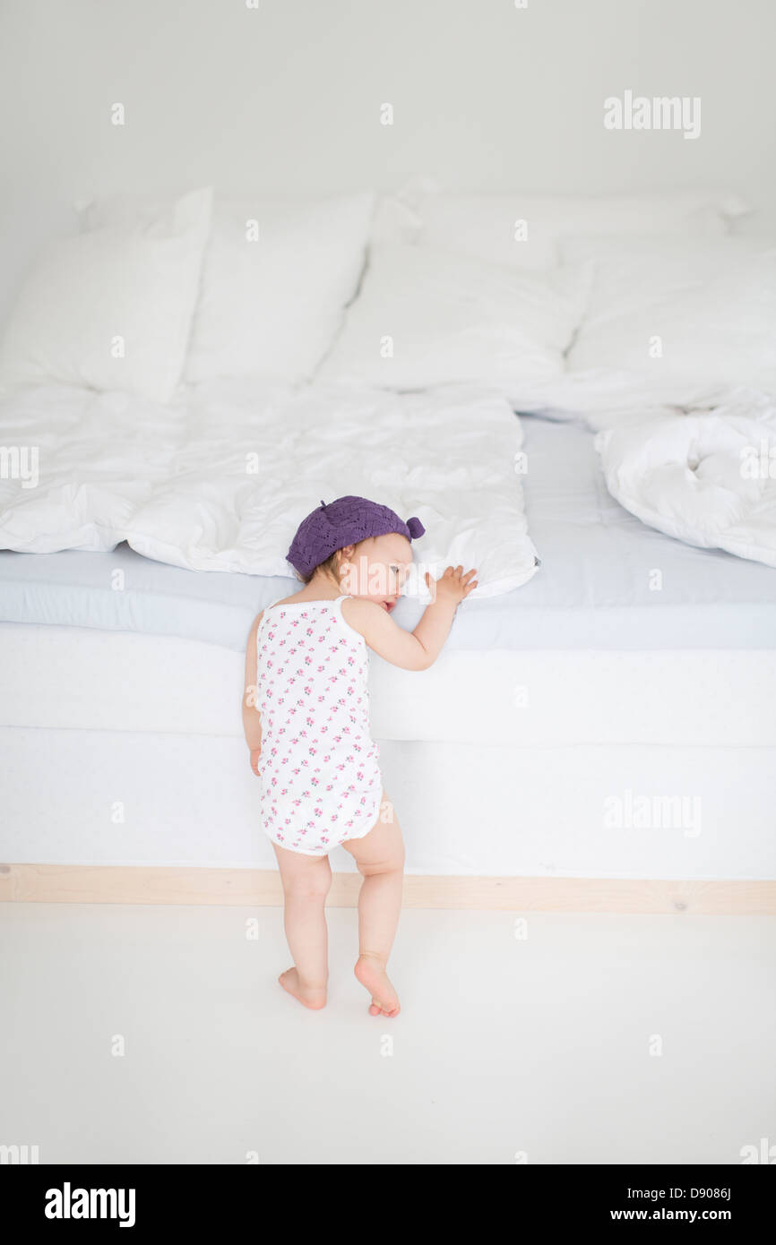 Little girl putting her head on bed Stock Photo Alamy