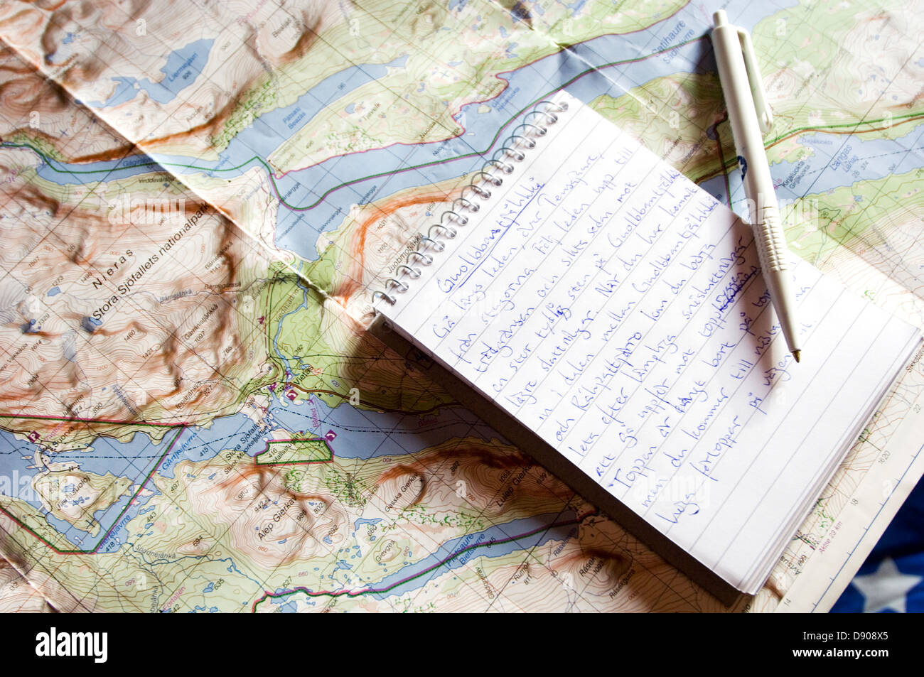 Notebook and pen on a map. Stock Photo