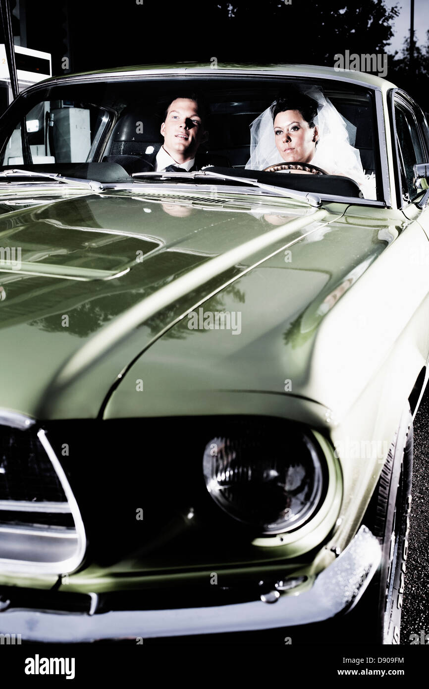 A bridal couple in a sports car, Sweden. Stock Photo