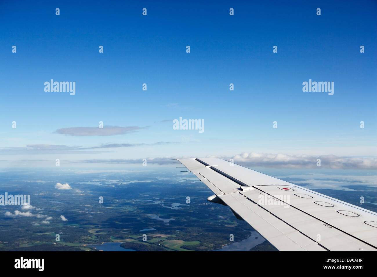 The wing of an aeroplane during a flight. Stock Photo