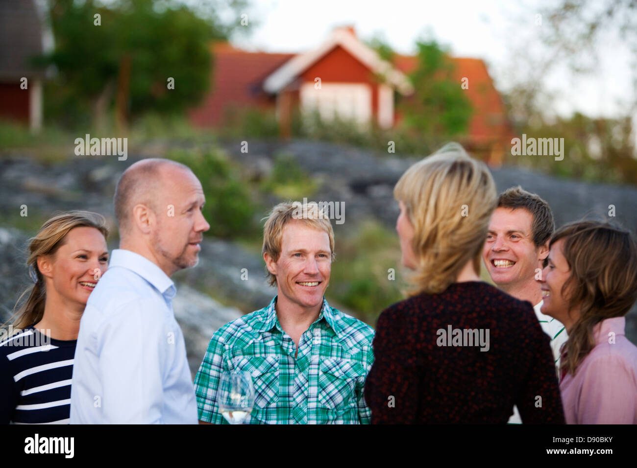 Six adults spending time together, Fejan, Stockholm archipelago, Sweden. Stock Photo