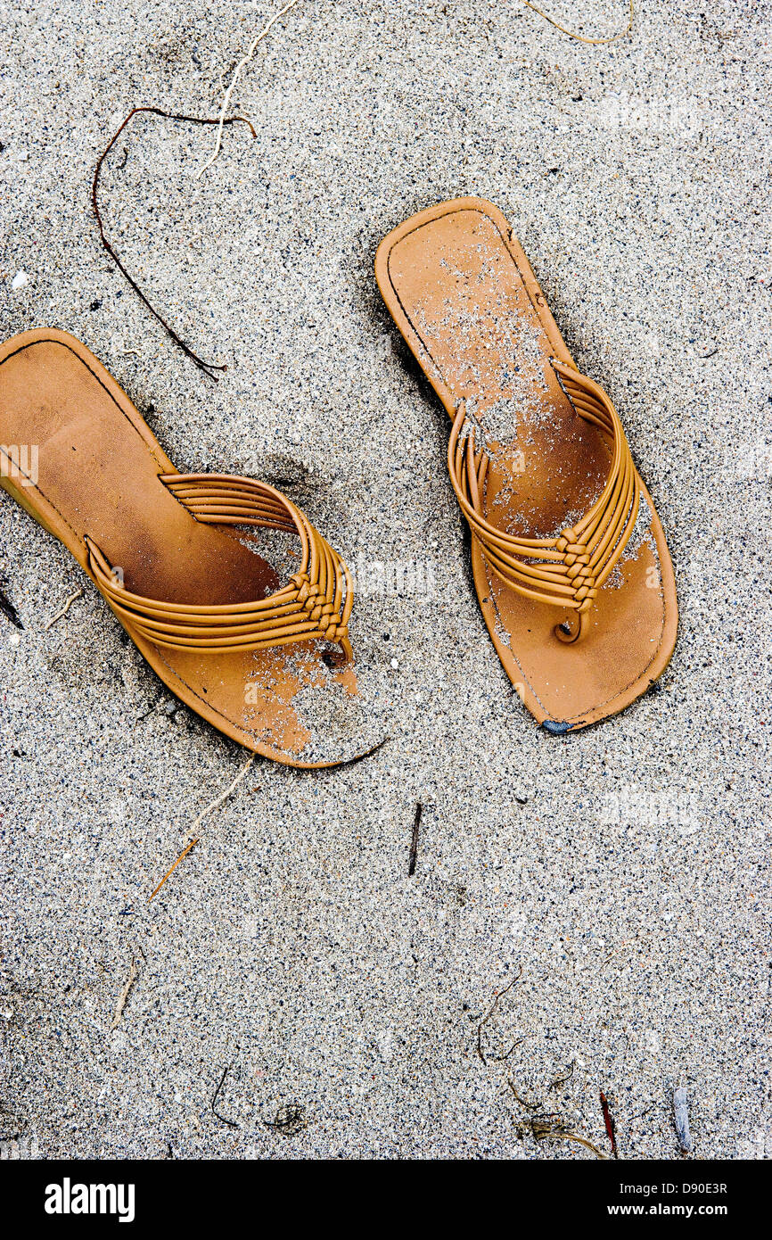 A pair of sandals in the sand Stock Photo Alamy