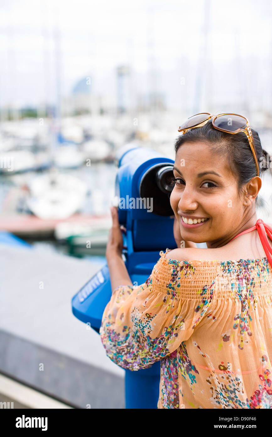 Portrait of woman using coin operated binoculars Stock Photo Alamy