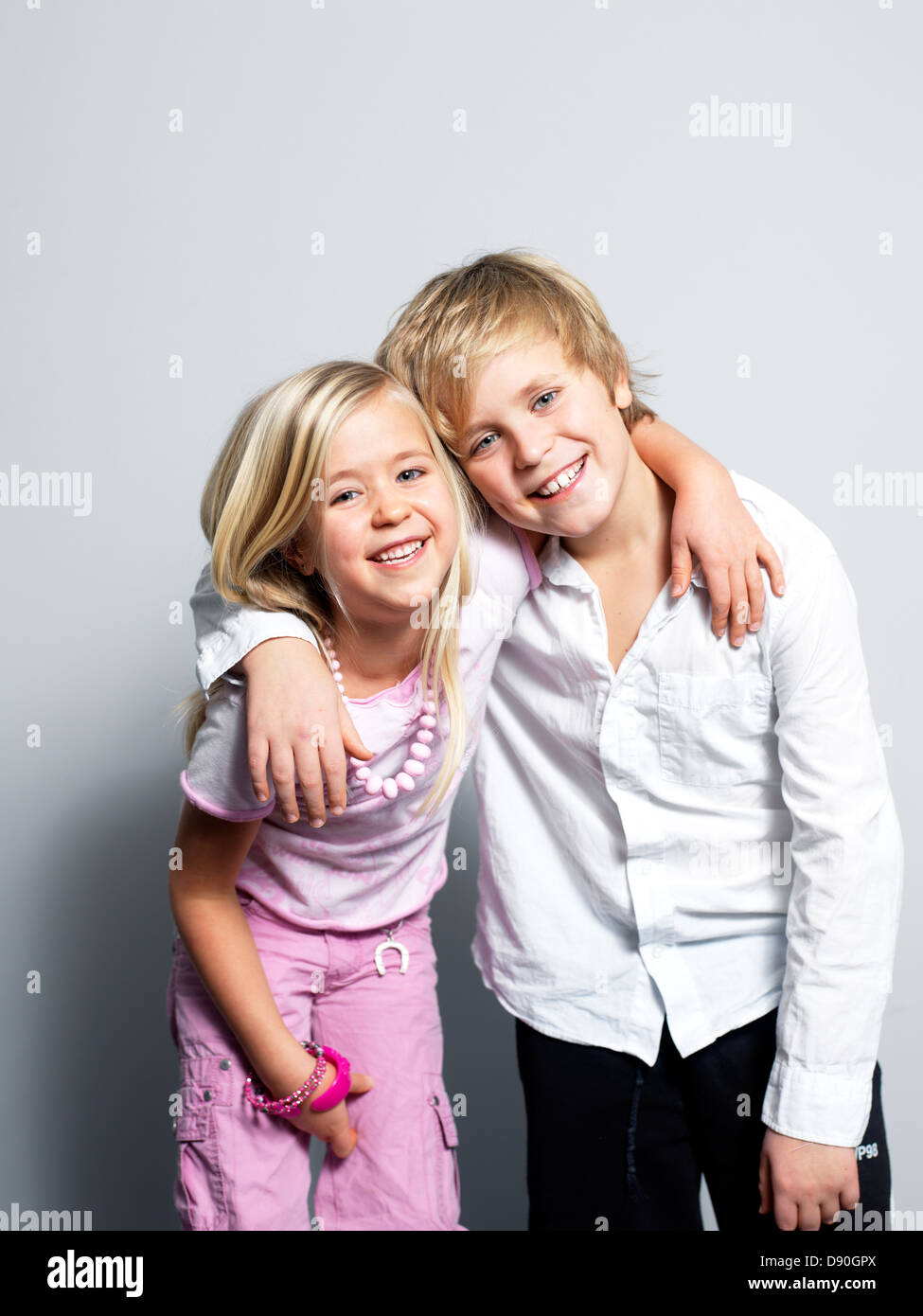 Boy and girl standing together Stock Photo - Alamy