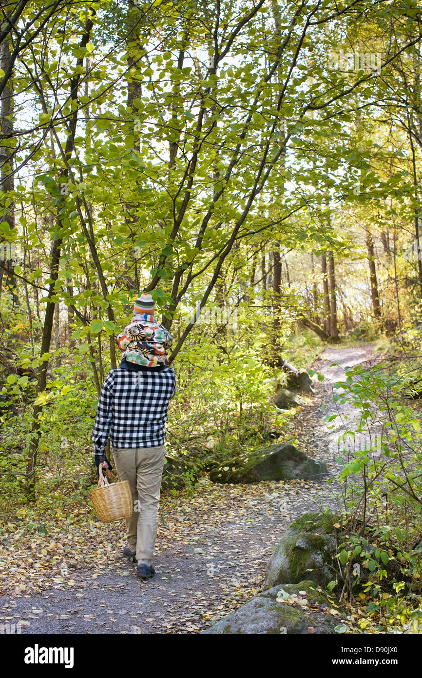Father and daughter walking through park Stock Photo - Alamy