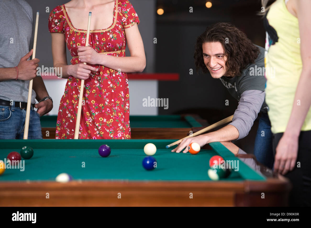 A man playing pocket billiards, friends watching Stock Photo Alamy