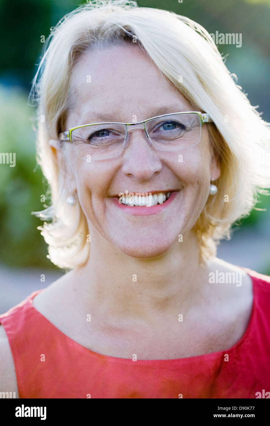 Portrait of smiling mature woman wearing spectacles Stock Photo